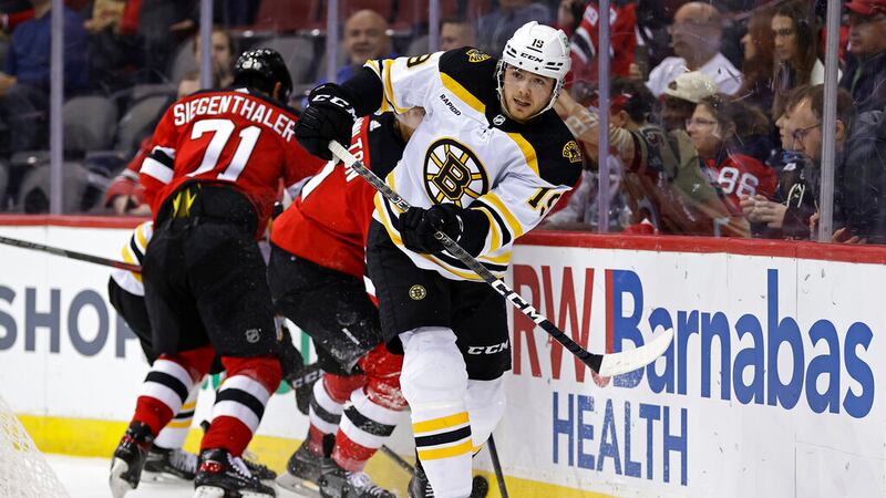 Boston Bruins center John Beecher (19) skates against the New Jersey Devils in the second...