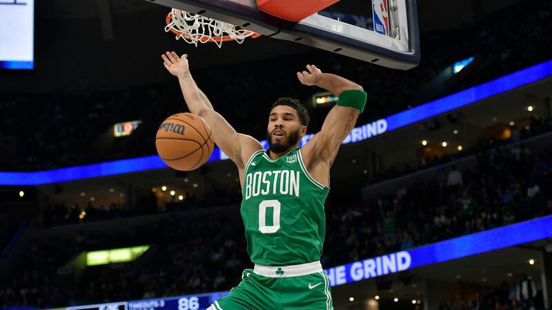 Boston Celtics forward Jayson Tatum (0) finishes a dunk in the second half of an NBA...